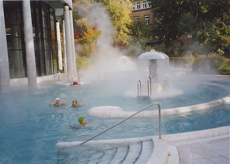 カラカラ浴場の屋外温泉の湯気の中で泳ぐ人々
